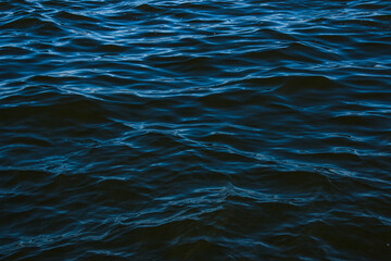 Abstract background of river water flow under the influence of light. The surface of the Dnieper...