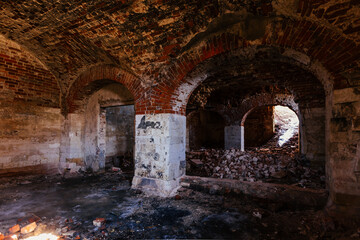 Old vaulted red brick cellar under abandoned building