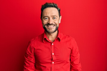 Middle age man wearing casual clothes with a happy and cool smile on face. lucky person.