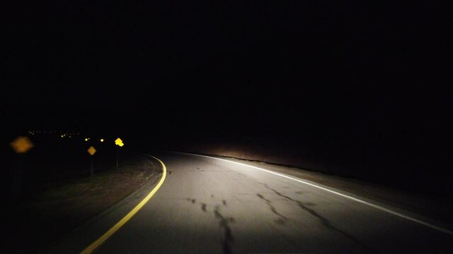 Driving On Highway Freeway Turnoff At Night With Yellow Reflective Tape Shining Back Then Transport Truck Appears