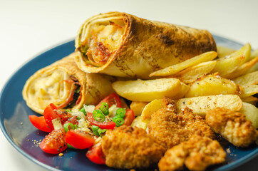 Tortilla wrap with chicken and beechwood smoked bacon served with chicken nuggets and chips