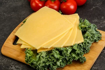 Foto op Plexiglas Sliced Gauda cheese over board © Andrei Starostin