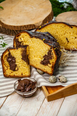 Home Made Panettone. Traditional Italian sweet bread. Panettone with a slice served on a wooden table.