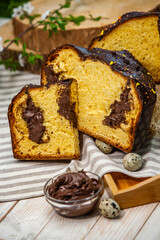 Home Made Panettone. Traditional Italian sweet bread. Panettone with a slice served on a wooden table.