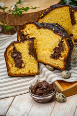 Fototapeta na wymiar Home Made Panettone. Traditional Italian sweet bread. Panettone with a slice served on a wooden table.