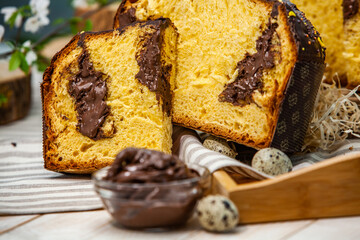 Home Made Panettone. Traditional Italian sweet bread. Panettone with a slice served on a wooden table.