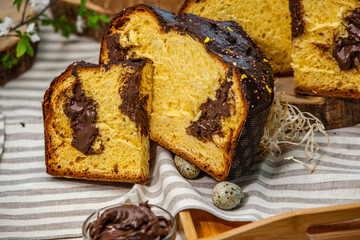 Home Made Panettone. Traditional Italian sweet bread. Panettone with a slice served on a wooden table.