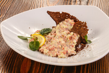 Tartar with beef meat served lemon
