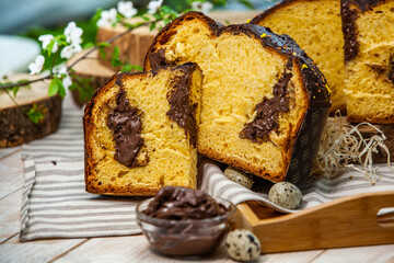 Home Made Panettone. Traditional Italian sweet bread. Panettone with a slice served on a wooden table.