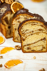 Home Made Panettone. Traditional Italian sweet bread. Panettone with a slice served on a wooden table.