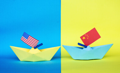 paper ship with national flag of China  and America Usa, concept of conflict, independence and...