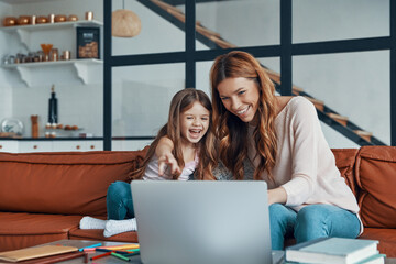 Young beautiful mother and her little daughter 