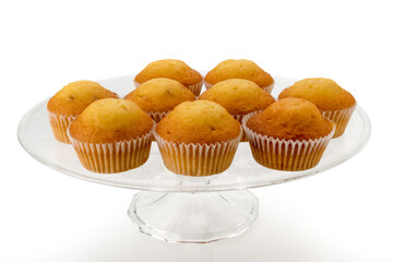 Muffins on clear glass raised plate, isolated on white background