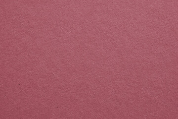 The surface of dark red cardboard. Paper texture with cellulose fibers. Purple-brown tinted background. Puce paperboard wallpaper. Beautiful textured backdrop. Top-down. Macro