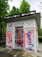 Art nouveau public toilets in a park in Turin, Italy, covered in graffiti