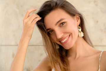Beauty model with natural makeup smiling in the city. Beauty in the city and lifestyle concept.