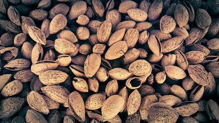 Pile of dried almonds in their shells