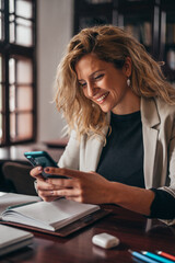 Businesswoman using a smartphone in her office