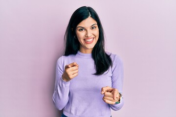 Young hispanic woman wearing casual clothes pointing fingers to camera with happy and funny face. good energy and vibes.