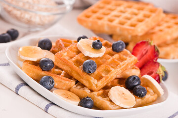 Waffles with blueberries, bananas and honey.