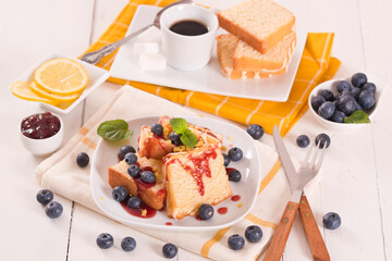 Lemon pund cake with blueberries and strawberry syrup.