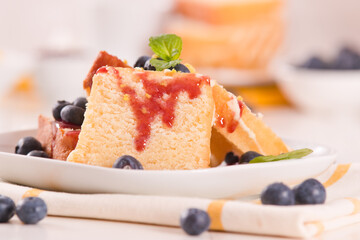 Lemon pund cake with blueberries and strawberry syrup.