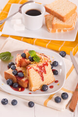 Lemon pund cake with blueberries and strawberry syrup.