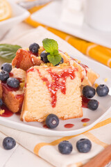 Lemon pund cake with blueberries and strawberry syrup.