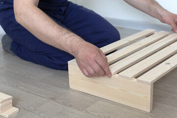 Manufacture and production of wooden products from boards and slats, close-up. Carpentry and production work