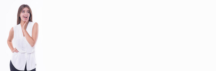 Fototapeta premium Beautiful young business girl surprised, happy on a white background.Copy space. Banner