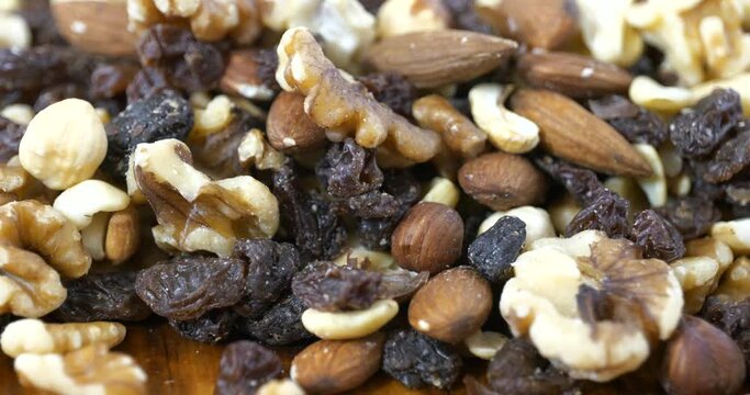 Slider shot of healthy gourmet trail mix with nuts and raisins close up