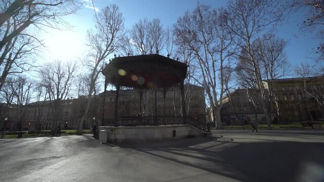 People walking in park Zrinjevac in Zagreb, view of the Croatian Academy of Sciences and Arts in autumn
