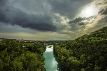 Heavy Clouds Over Soca River With Bicycle Bridge