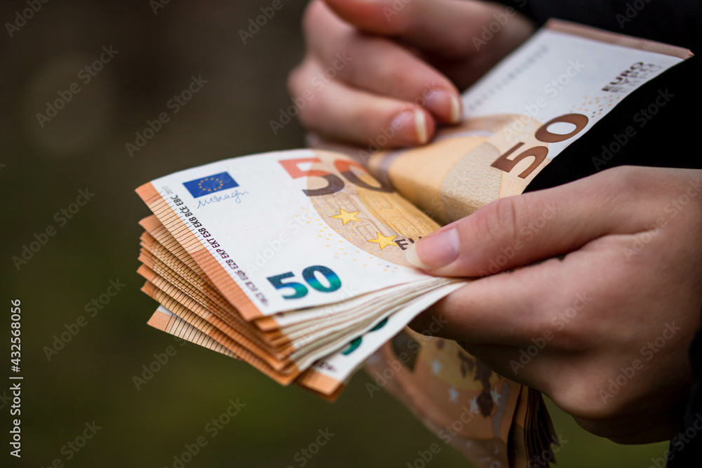 Poster Closeup of female hands counting EURO banknotes - world money, inflation and economy concept