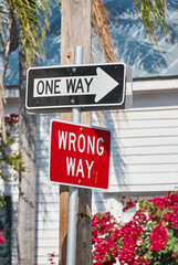 Fototapeta na wymiar Confusing street signs one way and wrong way