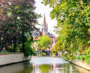Naklejka premium Bruges canals and church of Our Lady, Belgium