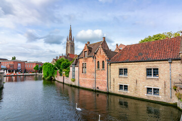 Fototapeta na wymiar Bruges canals and church of Our Lady, Belgium