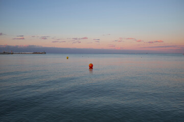 Beautiful calm evening sea with red buoy