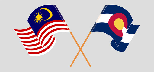 Crossed and waving flags of Malaysia and The State of Colorado