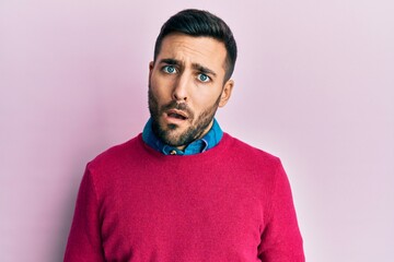 Fototapeta premium Young hispanic man wearing casual clothes in shock face, looking skeptical and sarcastic, surprised with open mouth