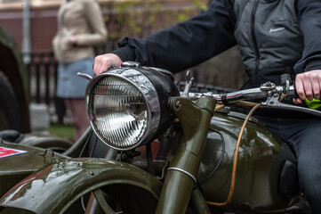 Fototapeta na wymiar Dnepr MT-11 motorcycle / motorcyclist / headlight / green bike / biker in black jacket