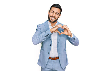Young hispanic man wearing business jacket smiling in love showing heart symbol and shape with...