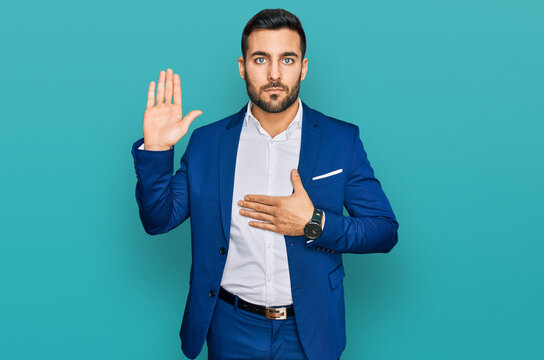 Young hispanic man wearing business jacket swearing with hand on chest and open palm, making a loyalty promise oath