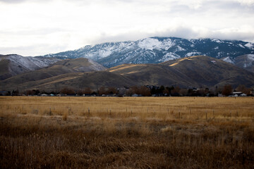 Field of dried grasses before C hill lit with a strip of light in carson city nevada