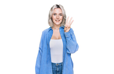 Young blonde girl wearing casual clothes showing and pointing up with fingers number three while smiling confident and happy.