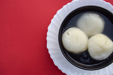 Traditional popular Indian sweet dish big size Rasgulla or rosogula , Bengali syrupy dessert sweets.