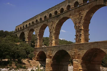 Papier Peint photo autocollant Pont du Gard Pont du Gard, Gard, Occitanie, France: Roman aqueduct over Gardon river: close-up detail of the upper tiers of arches