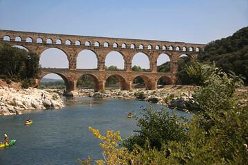 Pont du Gard, Gard, Occitanie, France: Roman aqueduct over Gardon river: general view from upstream with canoeists