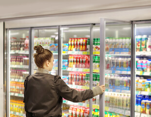 Woman choosing a dairy products at supermarket