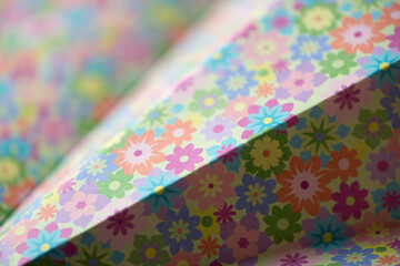 folded floral scrapbooking paper photographed using a macro lens, featuring a shallow depth of field
